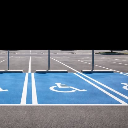 Blue painted ADA accessible parking stalls with stencils