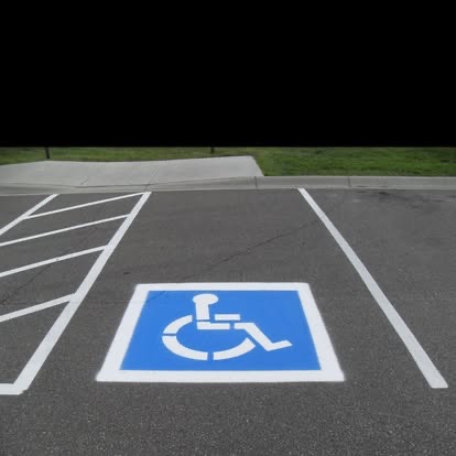 ADA accessibility symbol painted on parking lot
