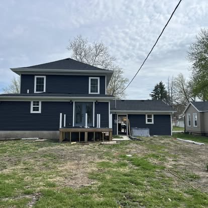 Two-story home with fresh navy siding and white trim