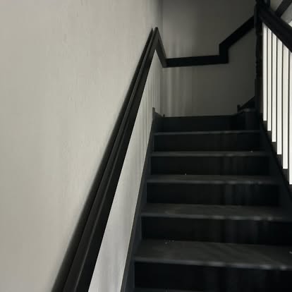 Modern interior stairwell with black trim and railings