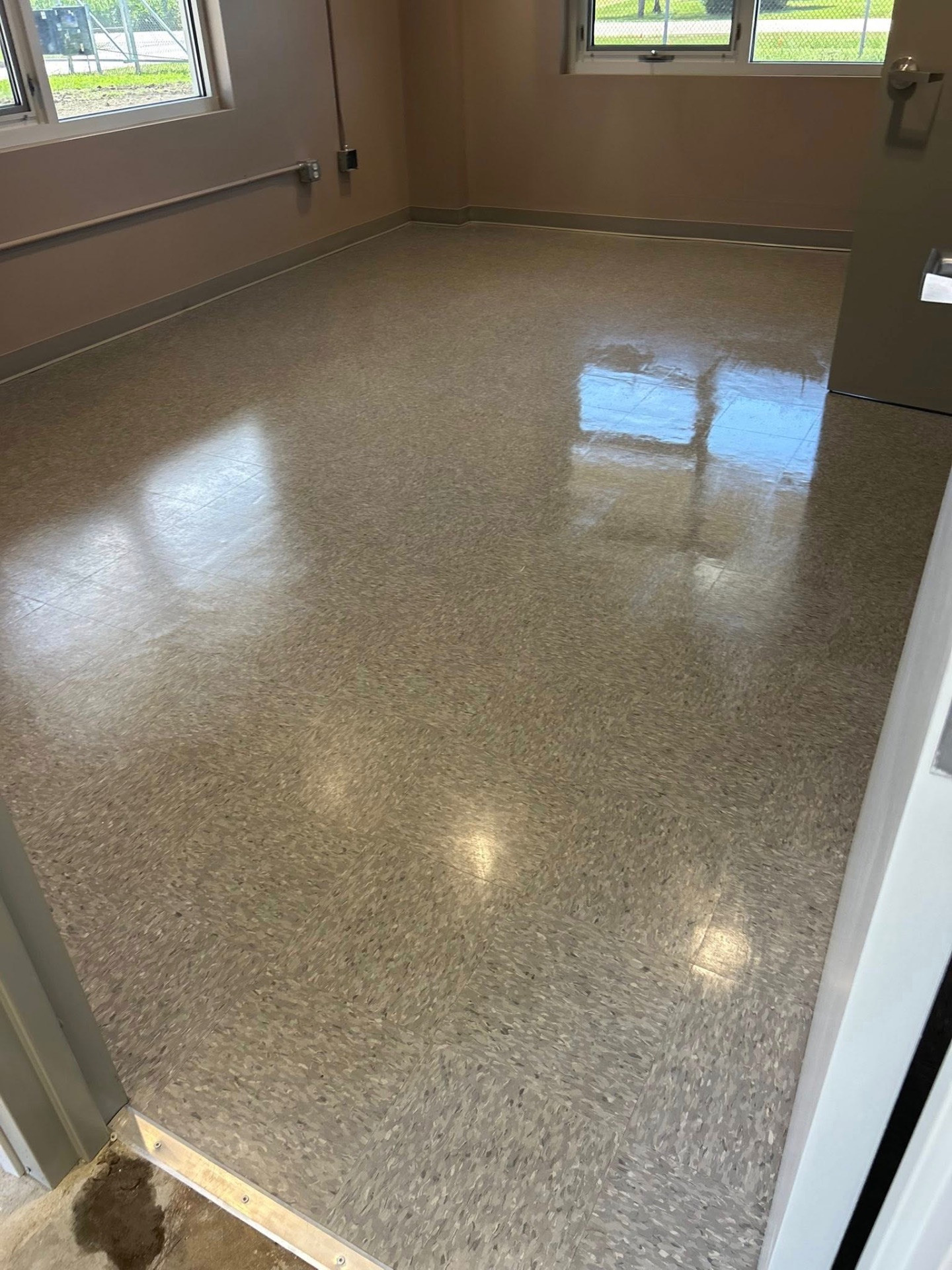 Freshly stripped and waxed VCT tile floor with high gloss finish